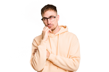 Young caucasian man cut out isolated relaxed thinking about something looking at a copy space.