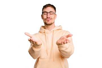 Young caucasian man cut out isolated folding lips and holding palms to send air kiss.