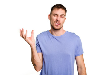 Young caucasian man cut out isolated doubting and shrugging shoulders in questioning gesture.