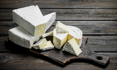 Brie cheese on the chopping Board.