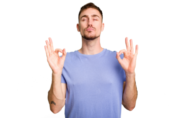 Young caucasian man cut out isolated relaxes after hard working day, she is performing yoga.