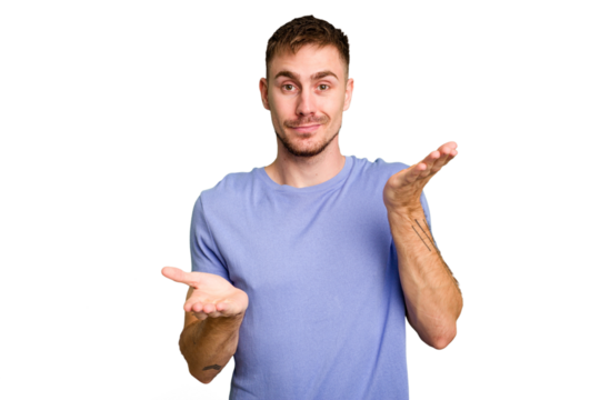 Young caucasian man cut out isolated makes scale with arms, feels happy and confident.