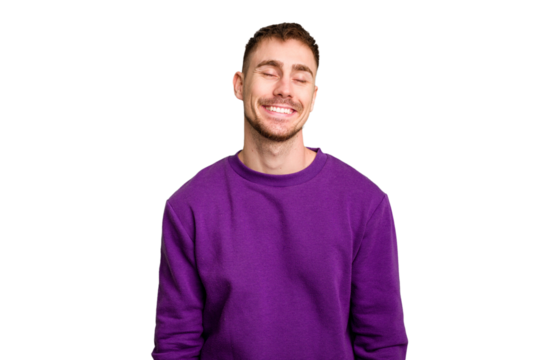 Young caucasian man cut out isolated laughs and closes eyes, feels relaxed and happy.