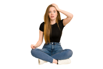 Young redhead woman sitting on the floor cut out isolated being shocked, she has remembered important meeting.