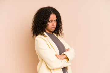 Young african american curly woman isolated suspicious, uncertain, examining you.