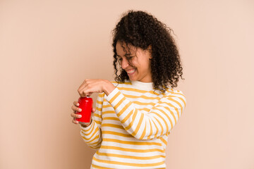 Young african american woman holding a cola isolated