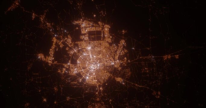 Erbil (Iraq) top view at night. Aerial view on modern city from space. Camera is flying above the city, moving forward. Vertical video. The north is on the left side