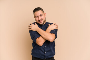 Adult latin man cut out isolated hugs, smiling carefree and happy.