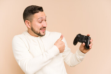 Adult latin man playing with a game controller isolated