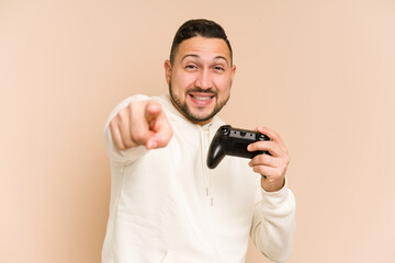 Fototapeta na wymiar Adult latin man playing with a game controller isolated