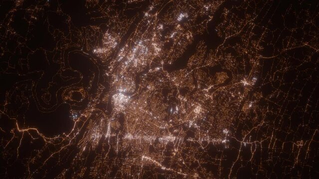 Chattanooga (Tennessee, USA) aerial view at night. Top view on modern city with street lights. Camera is zooming out, rotating clockwise
