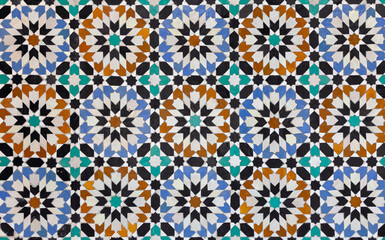 textures of ancient moroccan ceramic mosaic with geometric and floral pattern.