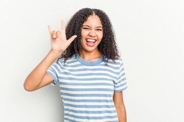 Young african american woman isolated on white background showing a horns gesture as a revolution concept.