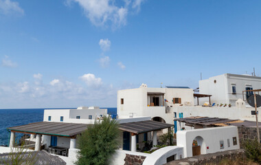 Fototapeta na wymiar Stromboli Island - Traditional White Houses with Blue Sky and Lava Rock Landscape
