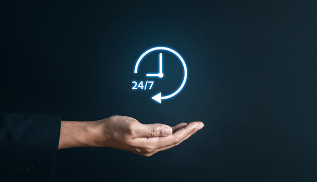 Nonstop service 24 hr concept. businessman hand holding virtual 24/7 with clock on hand for worldwide nonstop and full-time available contact of service concept. customer service.