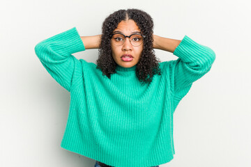 Young african american woman isolated on white background covering ears with hands trying not to hear too loud sound.