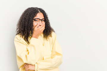 Young african american woman isolated on white background laughing happy, carefree, natural emotion.