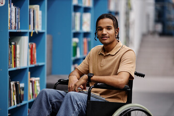 Black young man with disability in library at modern college