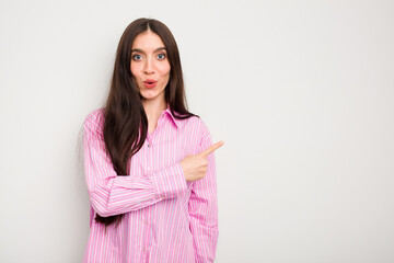 Young caucasian woman isolated on white background pointing to the side