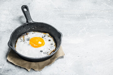 Fried egg in a frying pan.