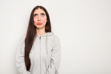 Young caucasian woman isolated on white background shouting very angry, rage concept, frustrated.