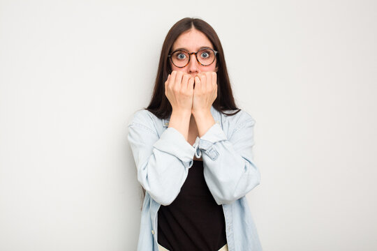 Young Caucasian Woman Isolated On White Background Biting Fingernails, Nervous And Very Anxious.