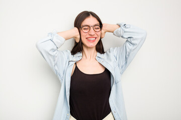 Young caucasian woman isolated on white background feeling confident, with hands behind the head.