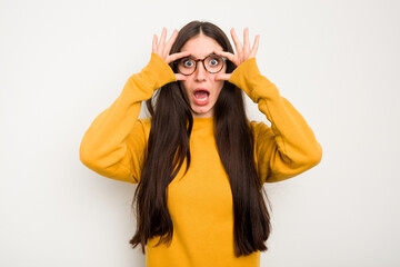 Young caucasian woman isolated on white background keeping eyes opened to find a success opportunity.
