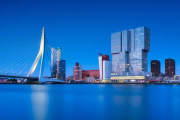 Badkamer foto achterwand Rotterdam, Holland. View of the Erasmus Bridge and the city center. Panoramic view. Cityscape in the evening. Skyscrapers and buildings. © biletskiyevgeniy.com