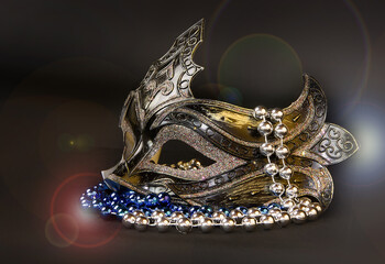 Beautiful carnival mask with beads and sequins on a dark background.