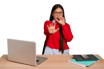 Young student asian woman in a workplace with a laptop isolated being shocked due to an imminent danger