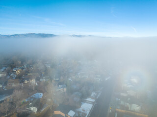foggy winter morning over Rocky Mountains and Fort Collins, Colorado, aerial view with a faint...
