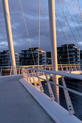 Naklejka premium Cityscape - pedestrian bridge Ypsilon in Drammen illuminated by sunset light
