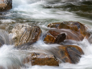 Beautiful waterfall with blurred crystalline waters photographed in long exposure