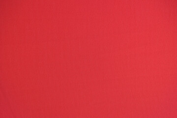 Unicolorous bright red textile as background.