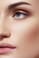 Half face of caucasian woman in close-up. Perfect clear skin and natural makeup