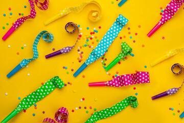 Abstract colored party background. Multi-colored party horns, serpentine ribbons, colored sprinkles...