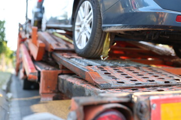 Close-up of several cars fixed in a row on truck.