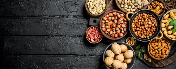 Assortment of different nuts in bowls.