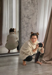 girl photographer with hemp squats in the studio