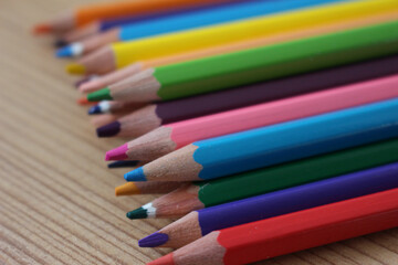 colorful wooden pencils for coloring close up on wooden ground