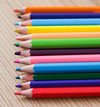 colorful wooden pencils for coloring close up on wooden ground
