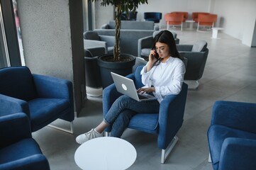 Beautiful Caucasian woman dreaming about something while sitting with portable net-book in modern cafe bar, young charming female freelancer thinking about new ideas during work on laptop computer