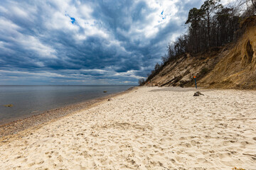 Coast of Baltic sea at the small beach next to high cliffs