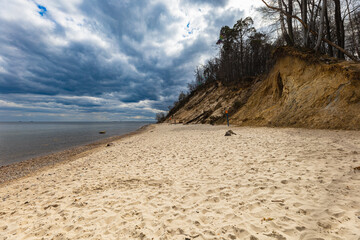 Coast of Baltic sea at the small beach next to high cliffs