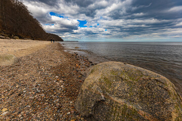 Coast of Baltic sea at the small beach next to high cliffs