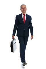 businessman going to work relaxed and a briefcase in hand
