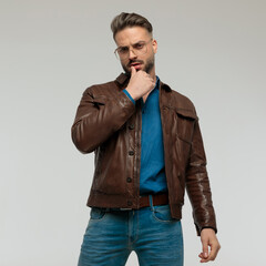 Fototapeta premium casual man with tough vibe is touching his lip