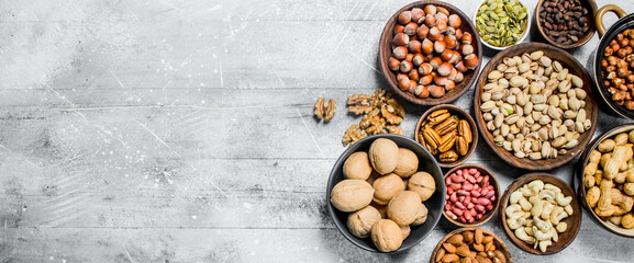 Assortment of different nuts in bowls.