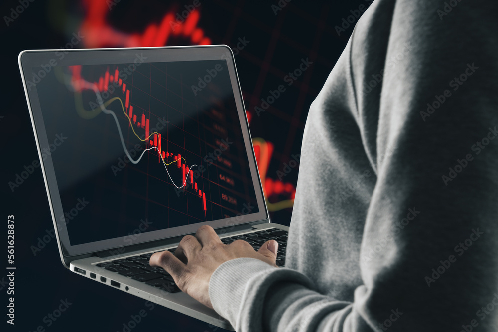 Poster Close up and side view of hand using laptop with abstract falling red forex chart on dark background. Economic decline and loss concept.